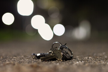 Close up of lost set of keys on a pathway at night