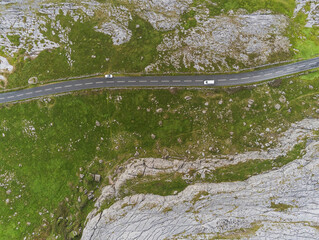 Aerial drone view, landscape in Burren region, county Clare Ireland. Small road between famous rock...