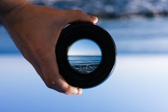 View through spyglass lens to the horizon above the water