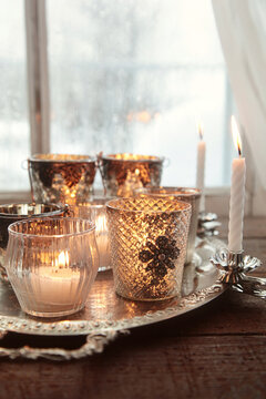 Closeup of candles in front of window