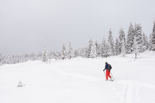 Man ski touring in a cloudy day