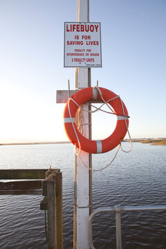 The pier at Marlo, Australia with life buoy at sunset