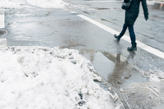 Snow and slush puddle on city street. New York City.