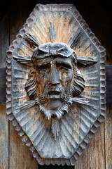 wooden face of Jesus Christ on cross