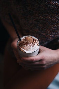 Woman holding cafe latte in her hands