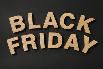 Text Black Friday made of wooden letters on black background