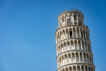 Leaning Tower of Pisa on clear blue sky, Romanesque style. (1173 - XIV Century). Piazza dei Miracoli (Square of Miracles) UNESCO world heritage site, Tuscany, Italy, Europe.