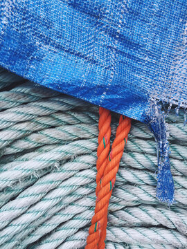 Close up of blue tart covering industrial ropes