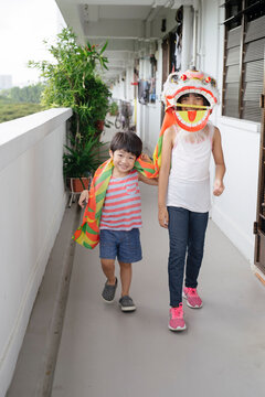 Two kids walking at typical Singapore HDB flat corridor