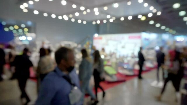 Blurred Background flow of many people inside space shopping center.