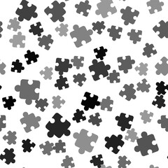 Black Puzzle pieces toy icon isolated seamless pattern on white background. Vector.