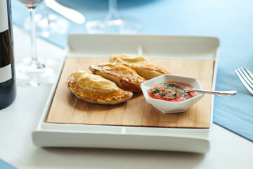 Spanish pies empanadas with sauce