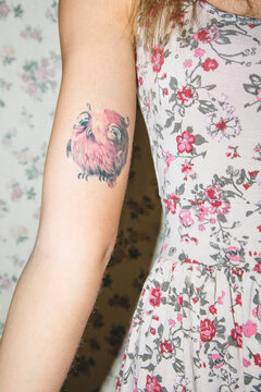 Owl tattoo on woman's arm