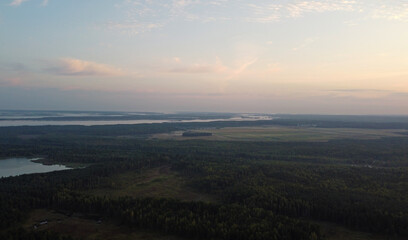 Top view at sunrise on a calm lake and forest