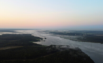 Top view at sunrise on a calm lake and forest