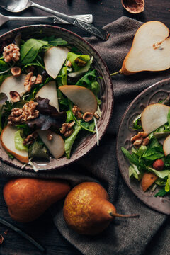 Delicious salad with pear, walnuts and hazelnuts