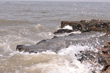 Water flowing over the rocks near Mumbai shore
