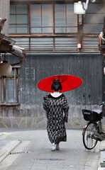 A traditional geisha out and about walking in Gion Kyoto Japan.