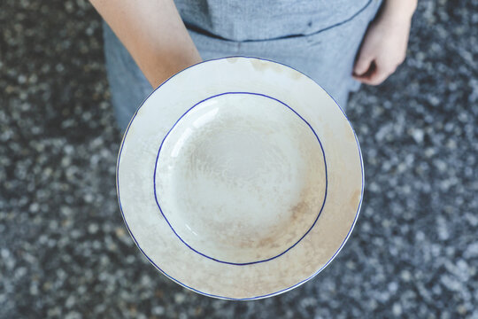 Vintage empty soup plate decorated with blue lines