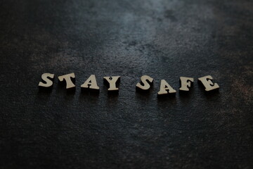 Fototapeta premium the word Stay Safe in wood type