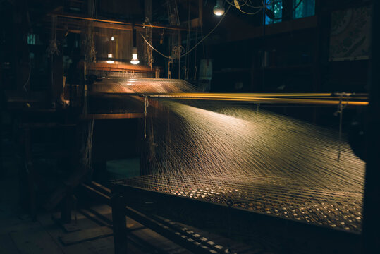 Vintage loom with threads stretching. Process of weaving