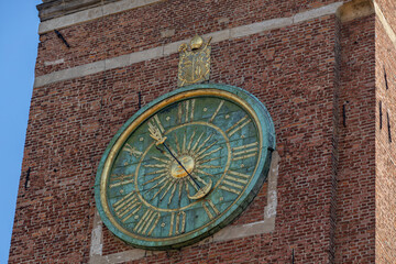 Fototapeta na wymiar antique clock on a brick tower in Krakow, Poland