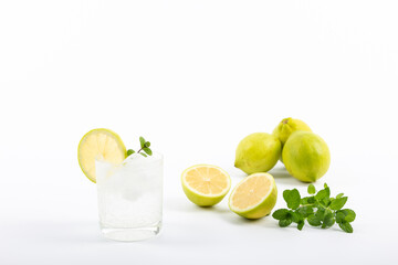 Glass of gin tonic with lemon on white background