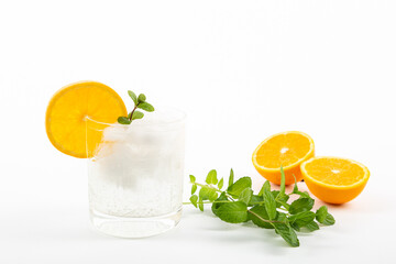 Glass of gin tonic with orange on white background