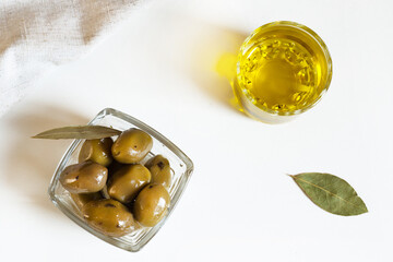 olive oil and olives in a glass bowl, top view