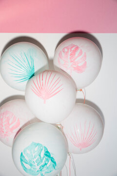 Festive hand painted summer balloons on white and pink background