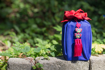 Korean traditional wrapping decorated with silk and an ornament.