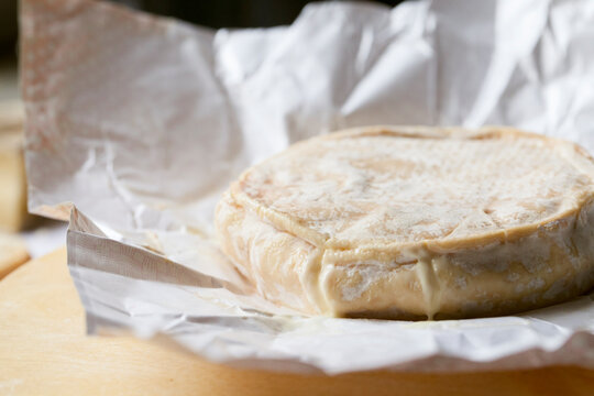 A wheel of freshly opened Camembert cheese.