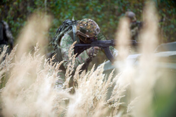 A soldier in a fighting position in cover.