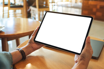 Mockup image of a woman holding digital tablet with blank white desktop screen