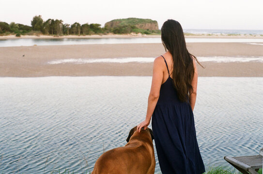 Woman with dog at the coast