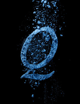 blue powder falling over letter Q
