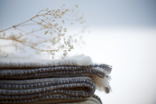 Stack Of Blankets With Dry Flower