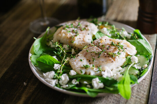 Halibut fillet with salad and Greek feta