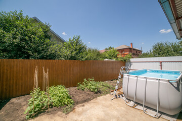 a large two-story house with a high pool. frame pool