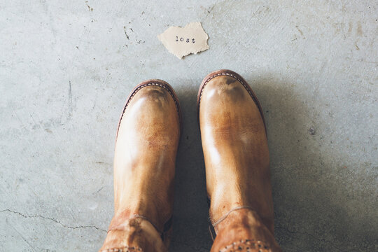 horizontal image of a woman standing in front of the word 'lost'