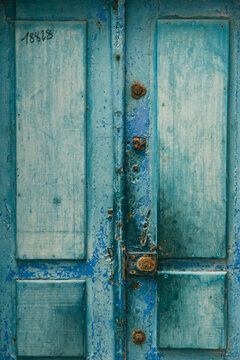 A blue painted door, full of texture and charm