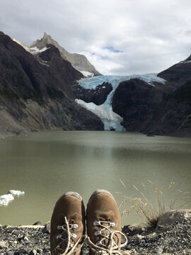 Woman's all terrain shoes in front of a glacier in Patagonia