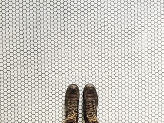 Woman standing on patterned white and black hexagon tile floor