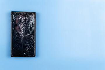 Broken phone with a hammer, on a blue background