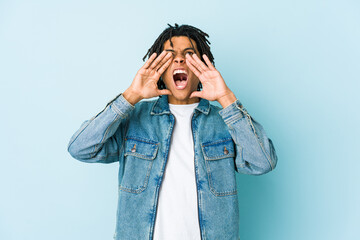 Young black man wearing a jeans jacket shouting excited to front.