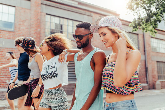 Multi ethnic group of friends walking in city