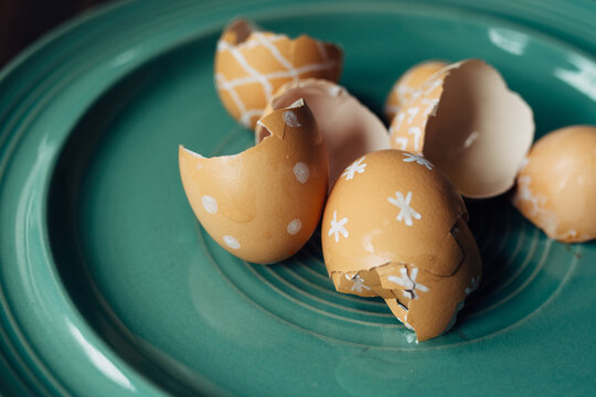 Brown egg shells with doodle decorations on them