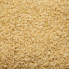 Dry Brown Rice background, top view. Overhead, from above, flat lay.