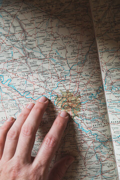 Finger pointing Paris on map