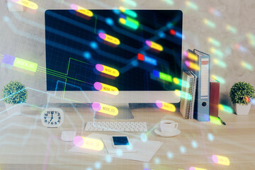 Double exposure of table with computer on background and data theme hologram. Data technology concept.